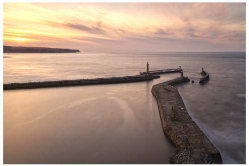 Whitby piers &amp; lighthouse, North Yorkshire coast, UK (SUNSET)